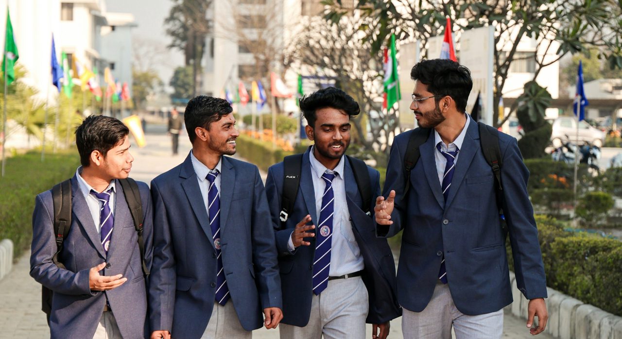 Four students walking together on campus